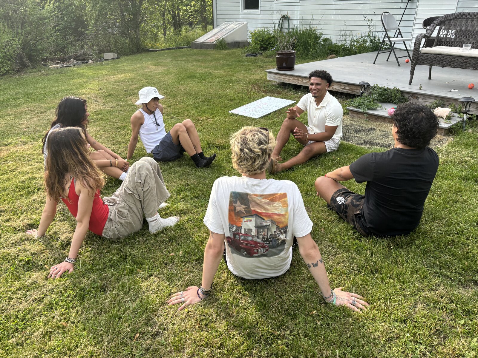 Friends sitting together outdoors in a circle